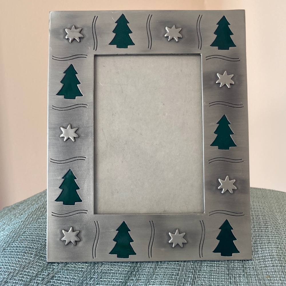 Metal Christmas frame ...silver toned with green Xmas trees and stars.